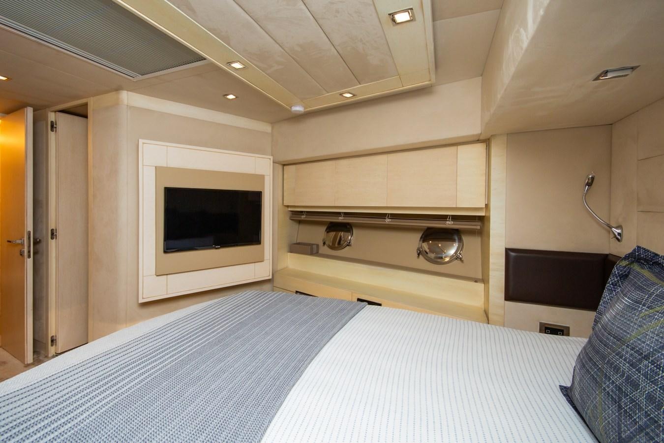 a bedroom with a bed and a television aboard AZIMUT 86S Yacht for Sale
