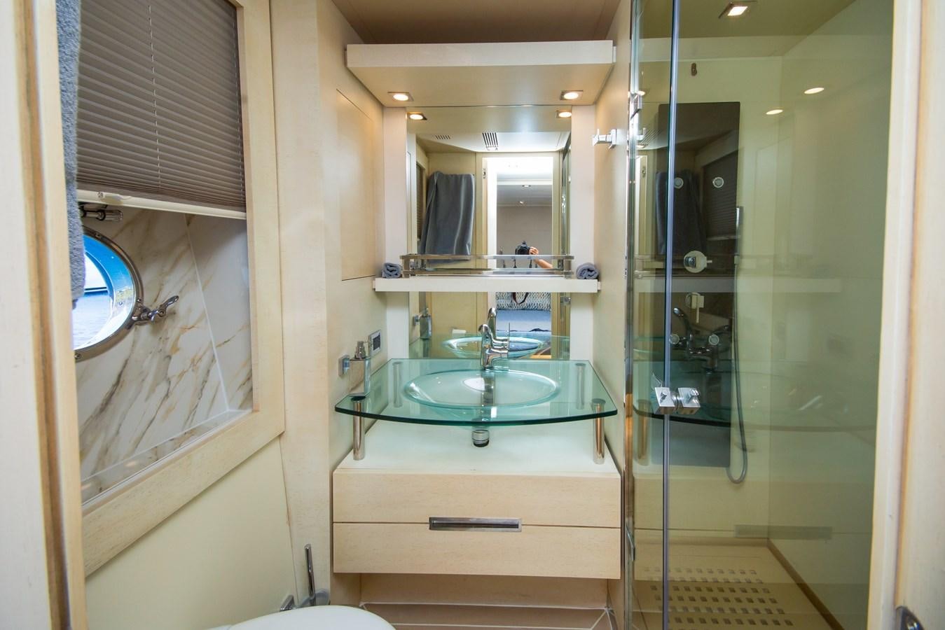 a bathroom with a sink and a mirror aboard AZIMUT 86S Yacht for Sale
