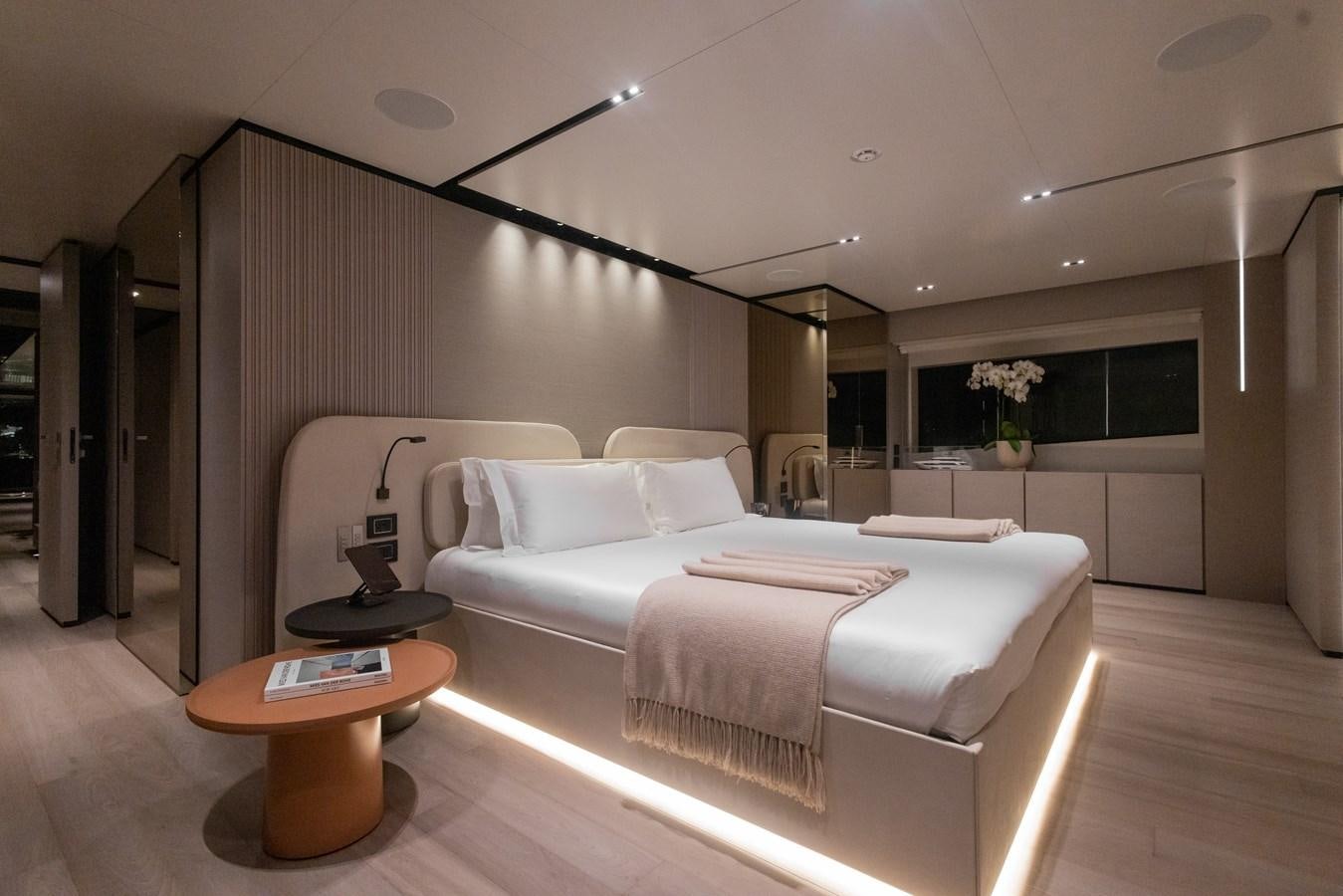 a modern bedroom with a white bed aboard BUONGIORNO Yacht for Sale