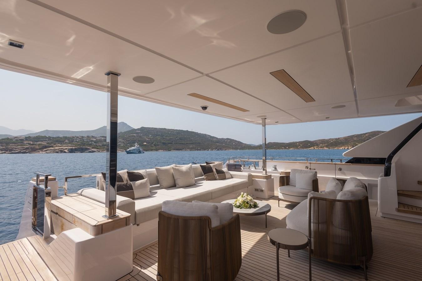 a room with a table and chairs and a large body of water aboard BUONGIORNO Yacht for Sale