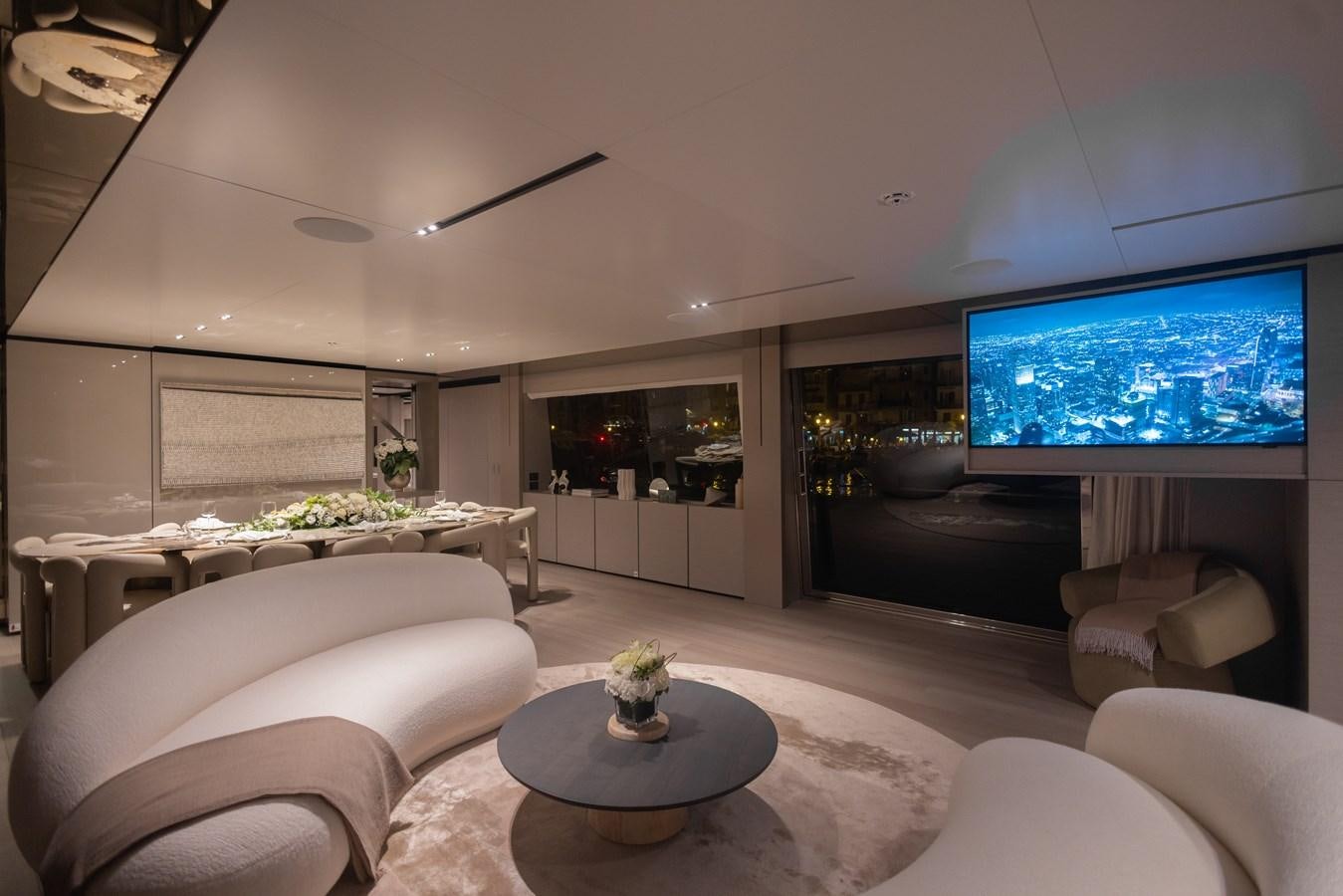 a living room with a large screen aboard BUONGIORNO Yacht for Sale
