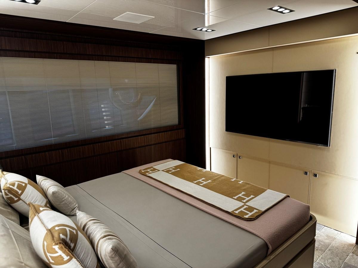 a room with a bed and a tv on the wall aboard M Yacht for Sale