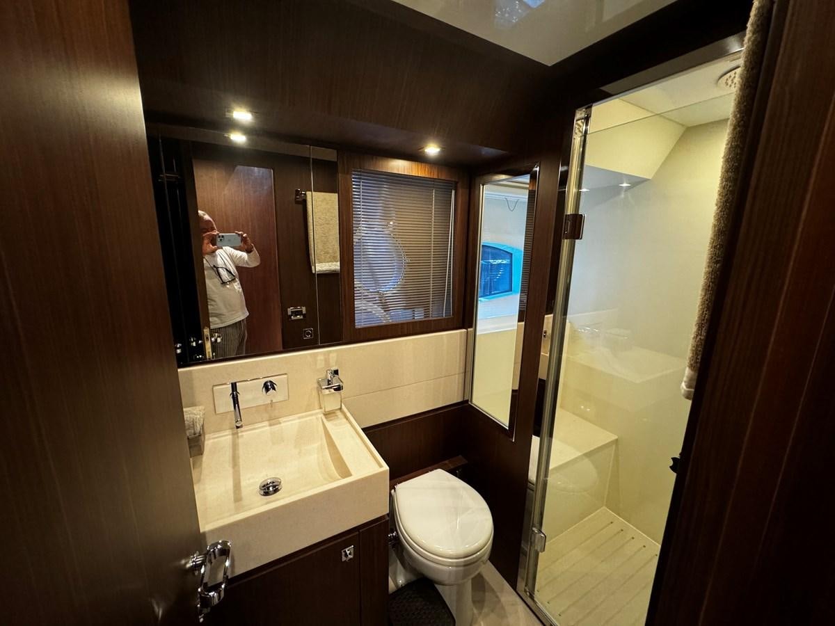 a person taking a picture of herself in a bathroom mirror aboard M Yacht for Sale