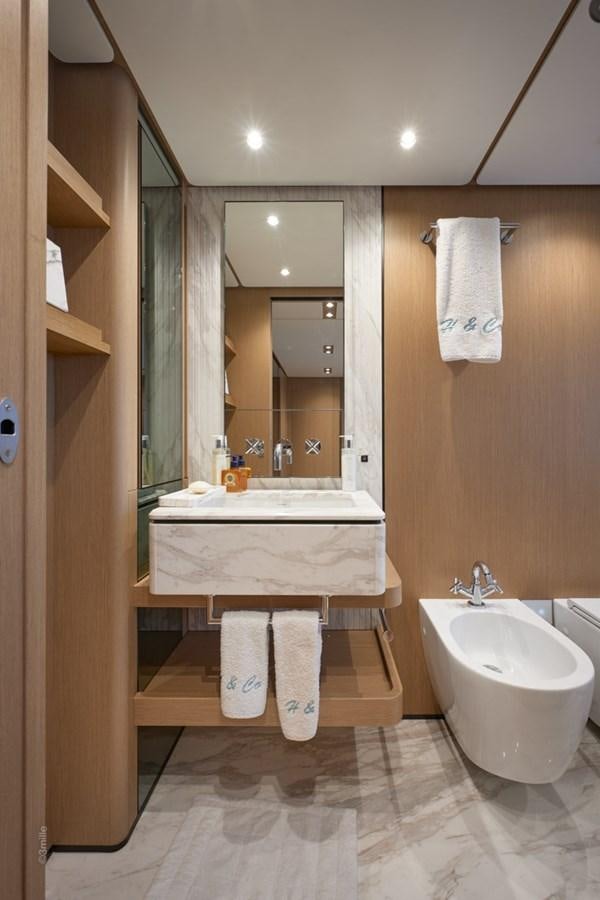 a bathroom with a sink and a mirror aboard H&CO Yacht for Sale