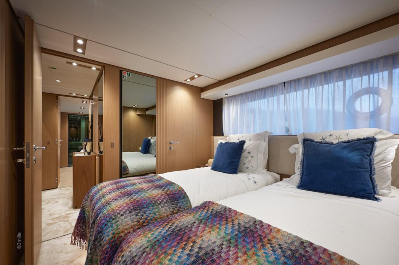 a bedroom with a bed and a door aboard H&CO Yacht for Sale