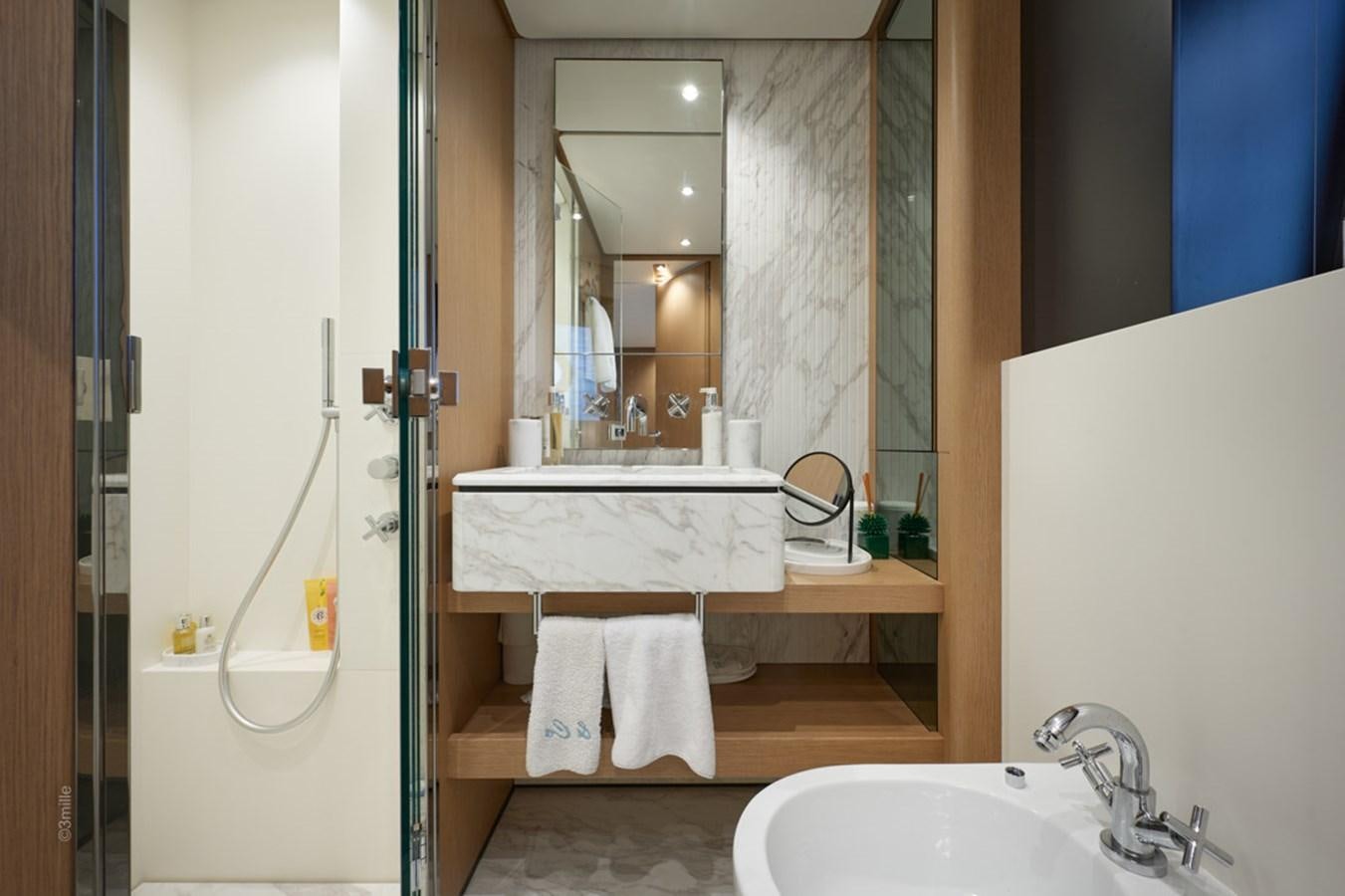 a bathroom with a sink and a mirror aboard H&CO Yacht for Sale