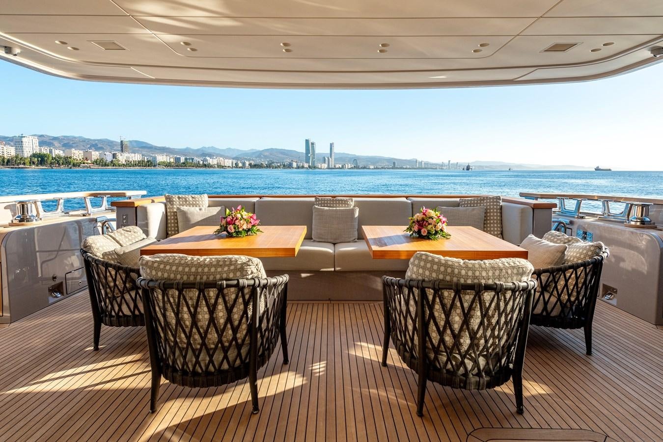 a room with a table chairs and a view of the city aboard SPERANZA II Yacht for Sale