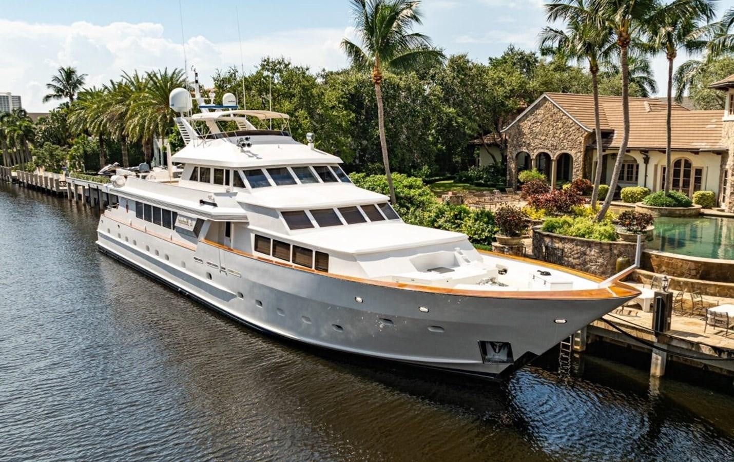 a large white boat sits at a dock aboard LE MONTRACHET Yacht for Sale