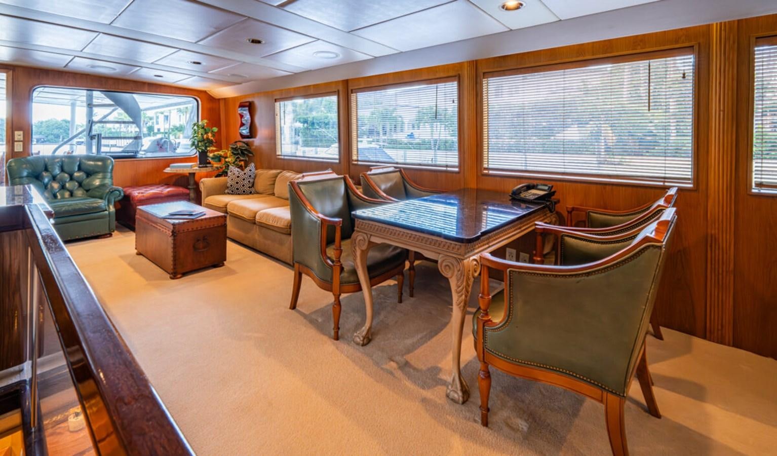 a room with a table and chairs aboard LE MONTRACHET Yacht for Sale
