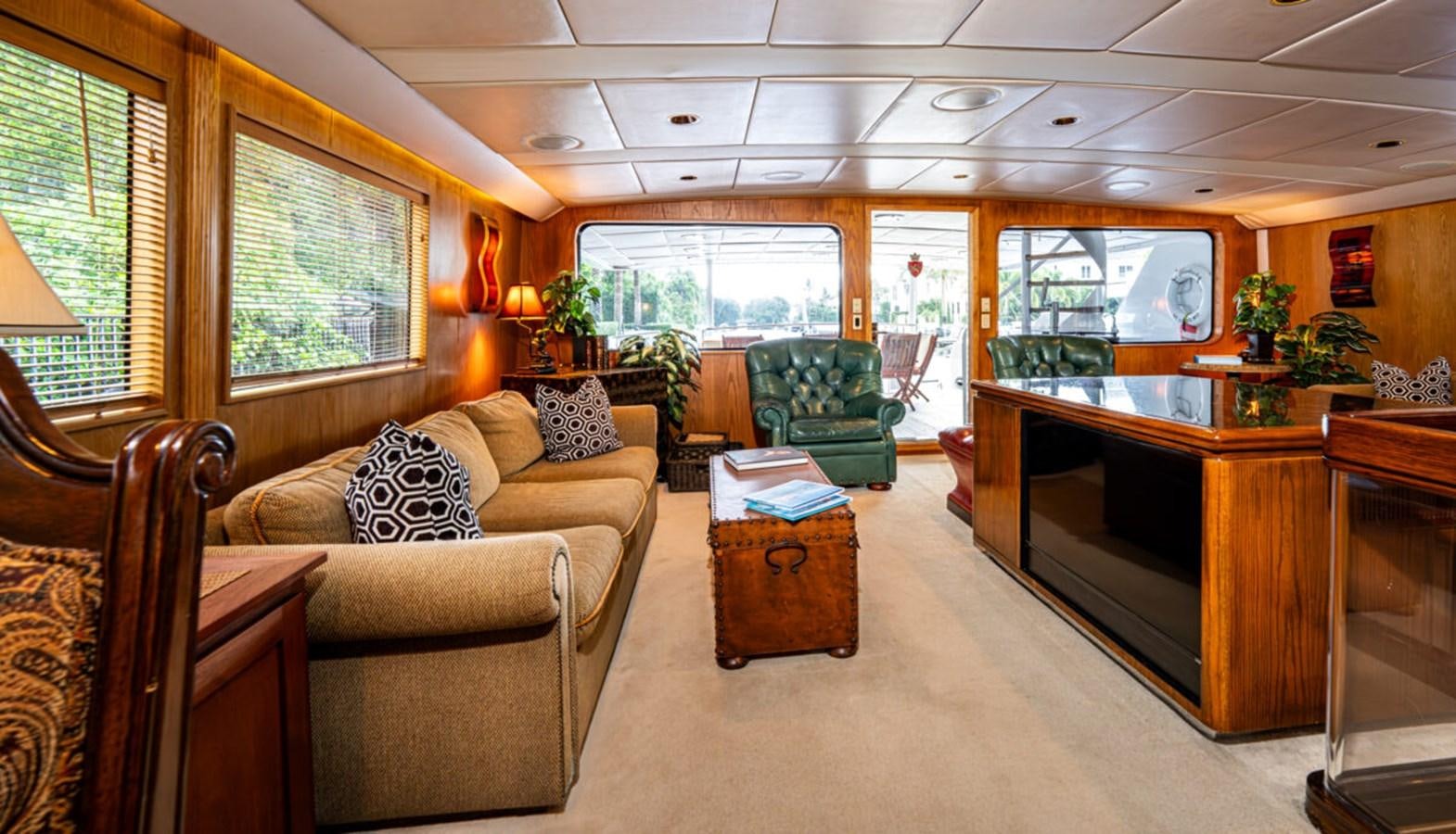 a living room with a couch and a television aboard LE MONTRACHET Yacht for Sale