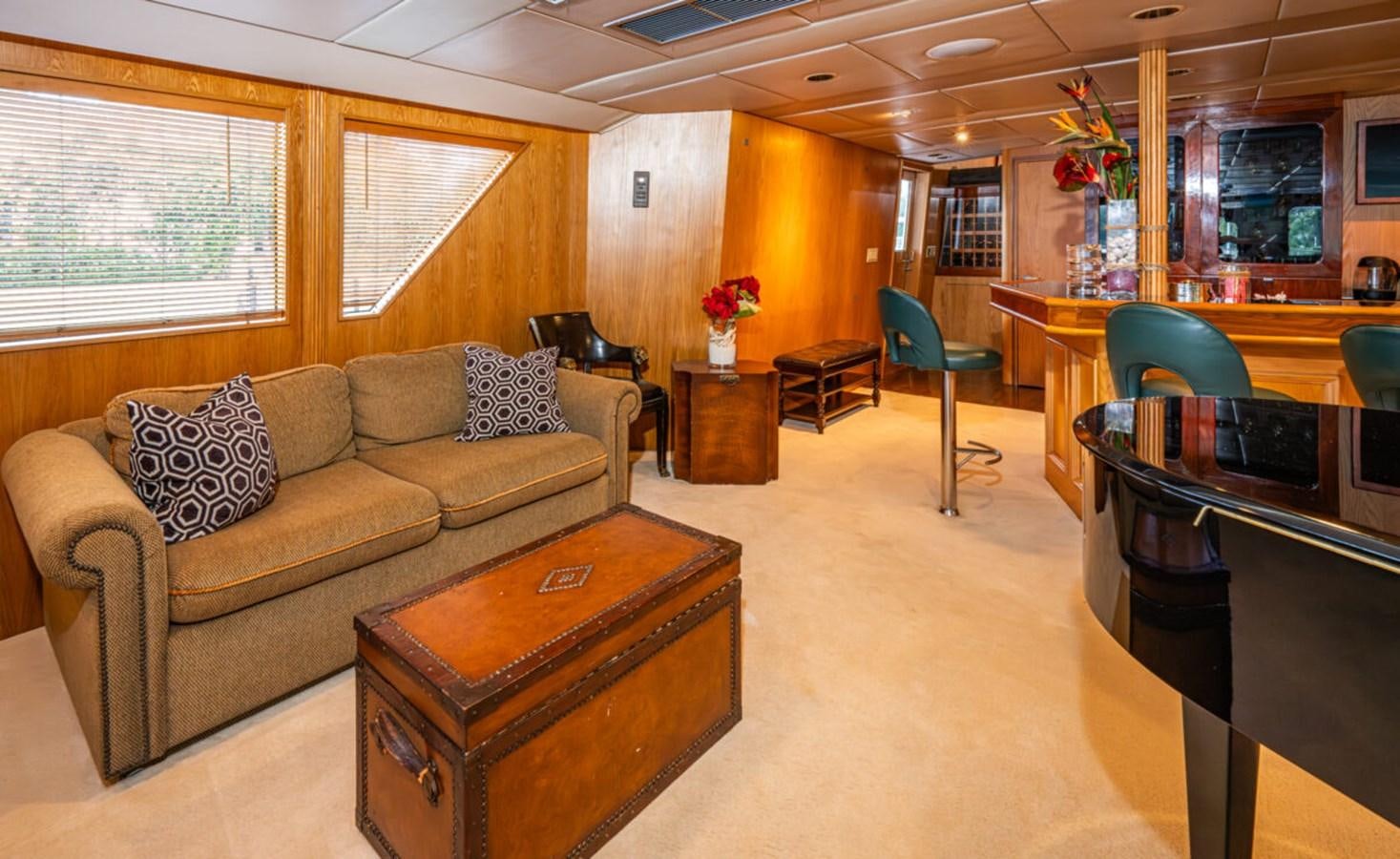 a living room with a couch and a coffee table aboard LE MONTRACHET Yacht for Sale