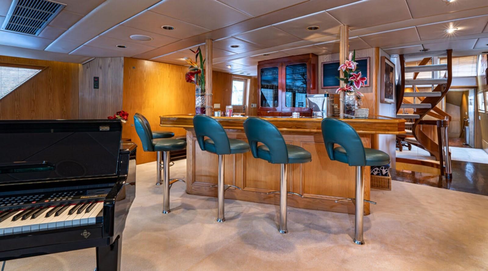 a room with a piano and chairs aboard LE MONTRACHET Yacht for Sale