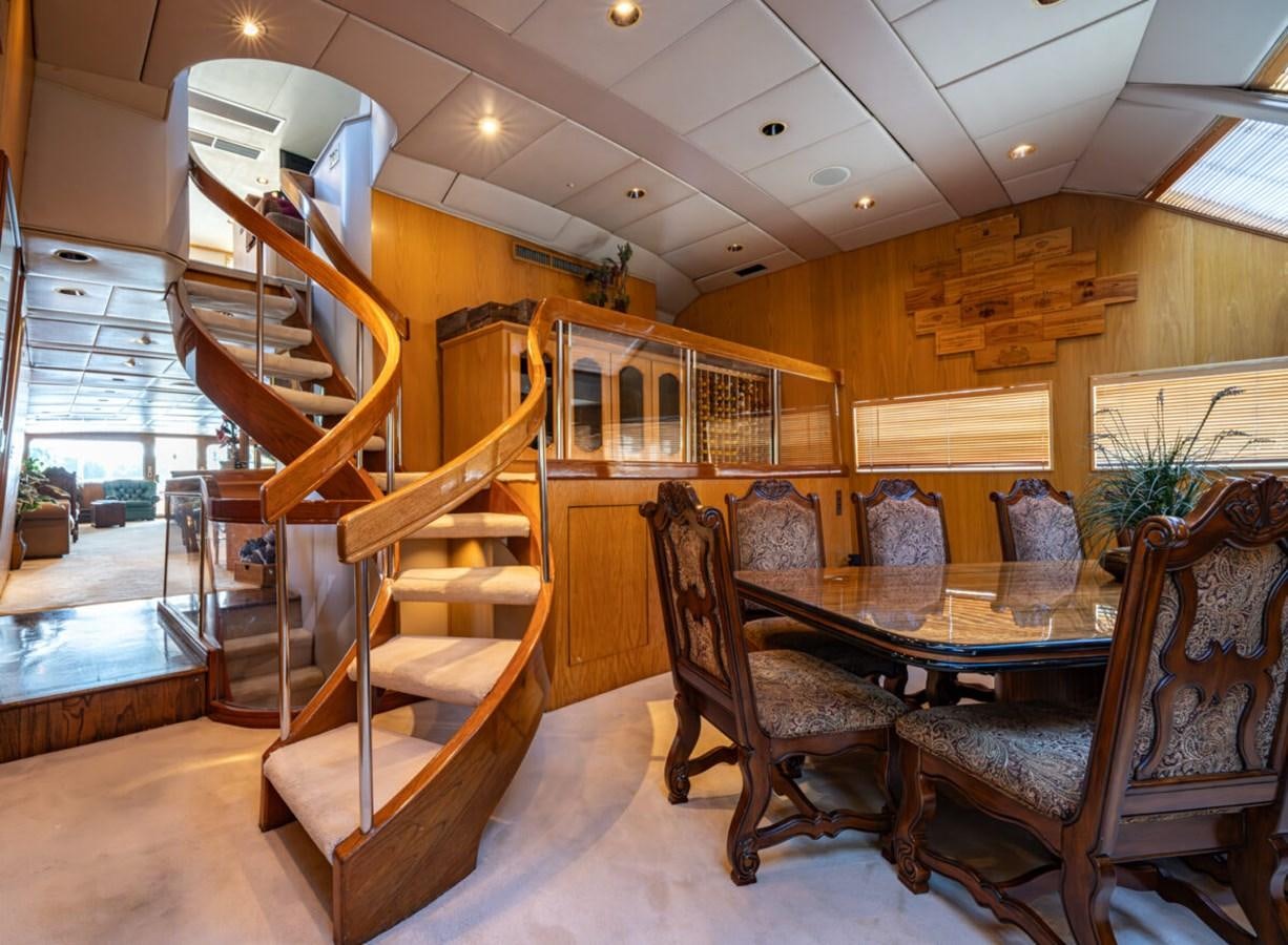 a dining room with a staircase aboard LE MONTRACHET Yacht for Sale