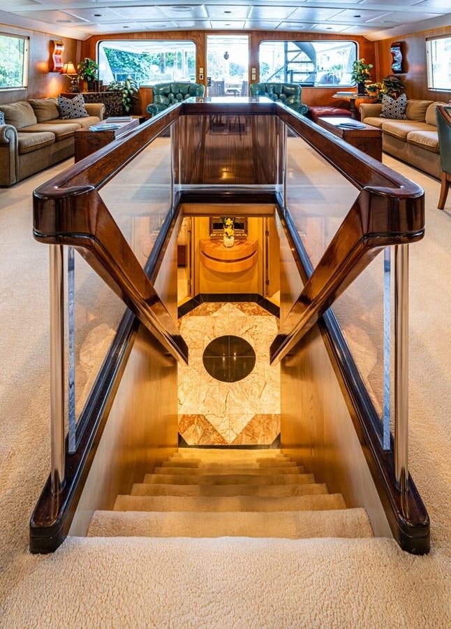 a large wooden table in a room aboard LE MONTRACHET Yacht for Sale