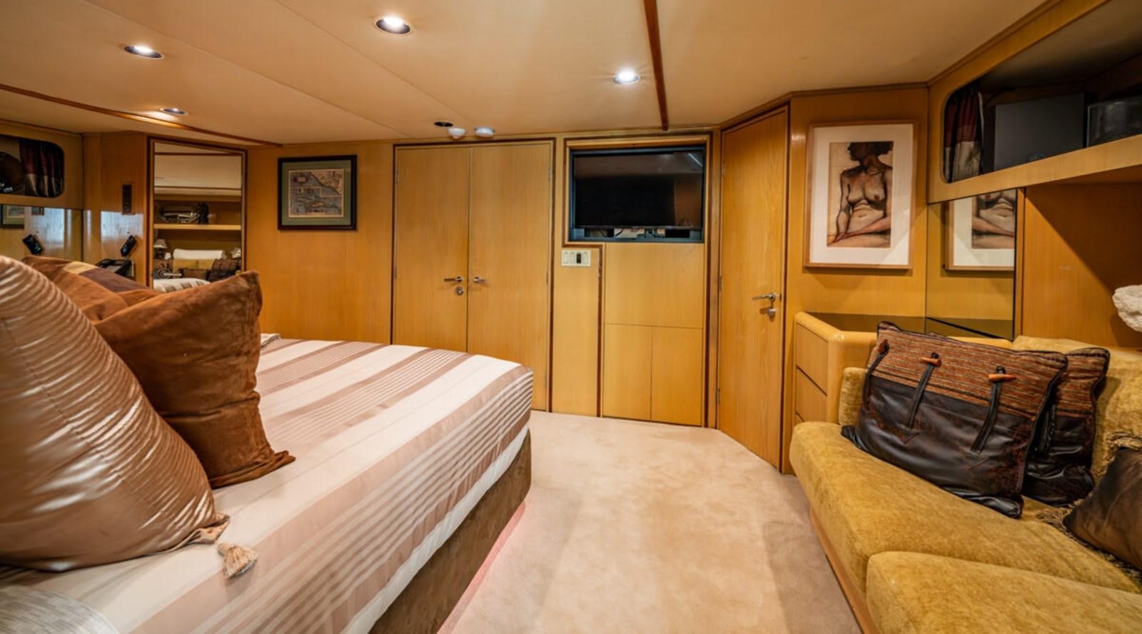 a bedroom with a bed and a television aboard LE MONTRACHET Yacht for Sale