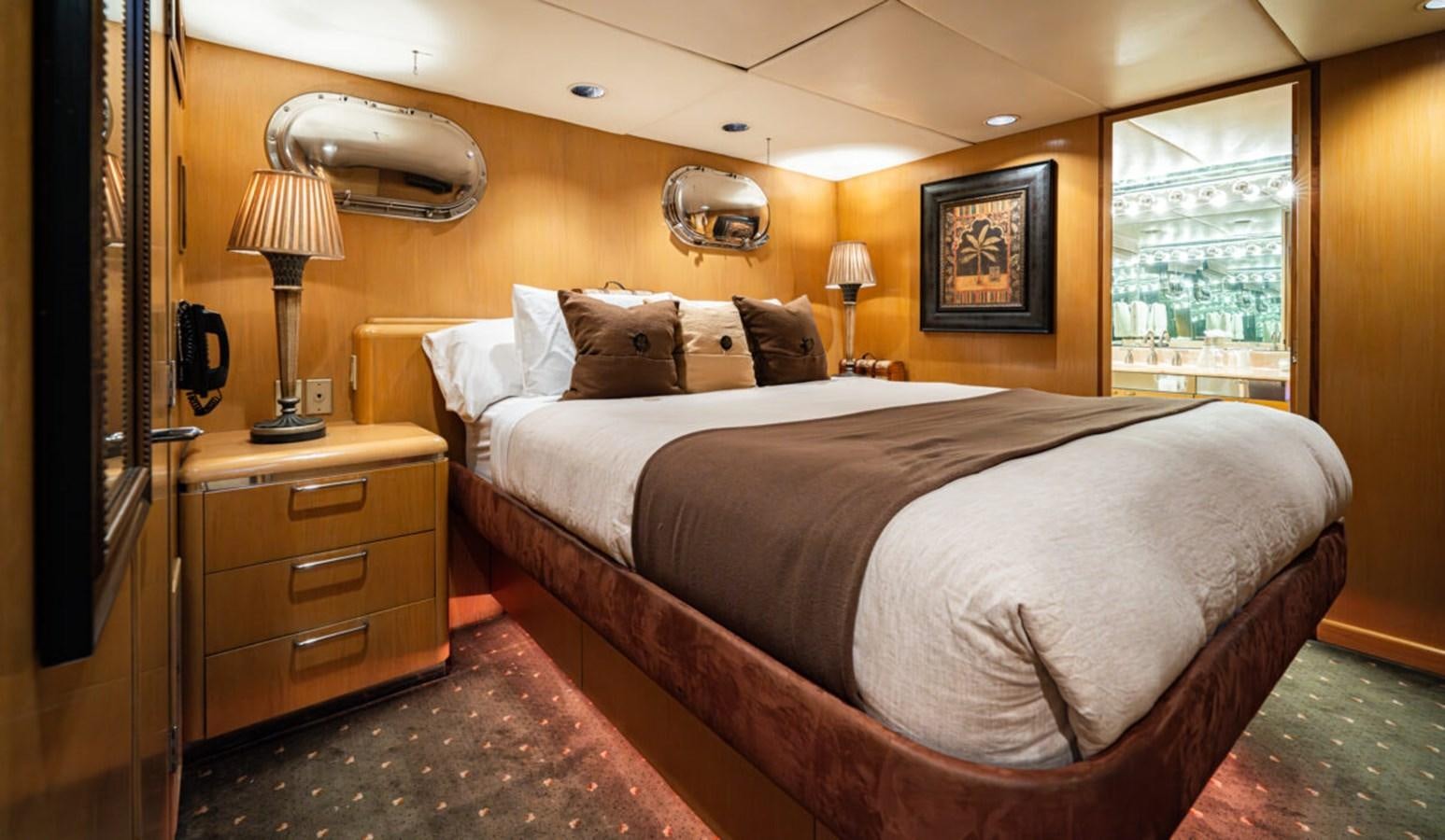 a bed with a white sheet aboard LE MONTRACHET Yacht for Sale