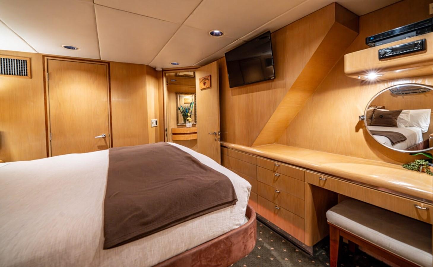 a bedroom with a bed and a television aboard LE MONTRACHET Yacht for Sale