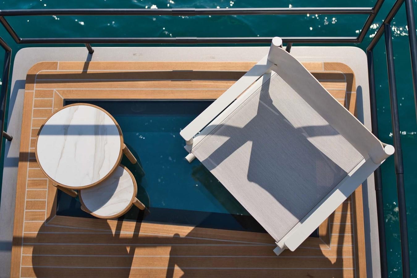 a toilet and a pillow on a bench aboard ROCK X Yacht for Sale