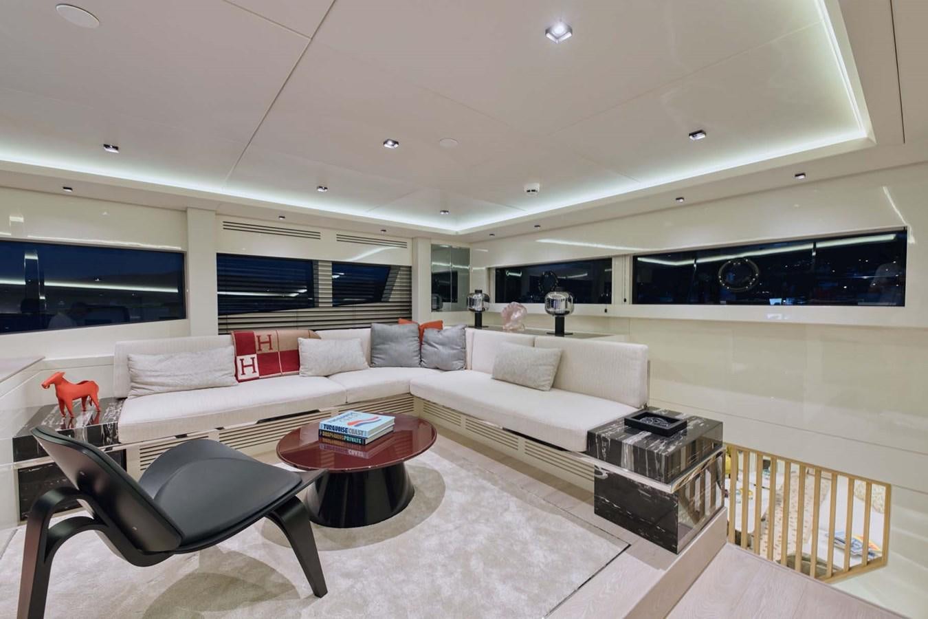 a living room with a couch and a table aboard ROCK X Yacht for Sale
