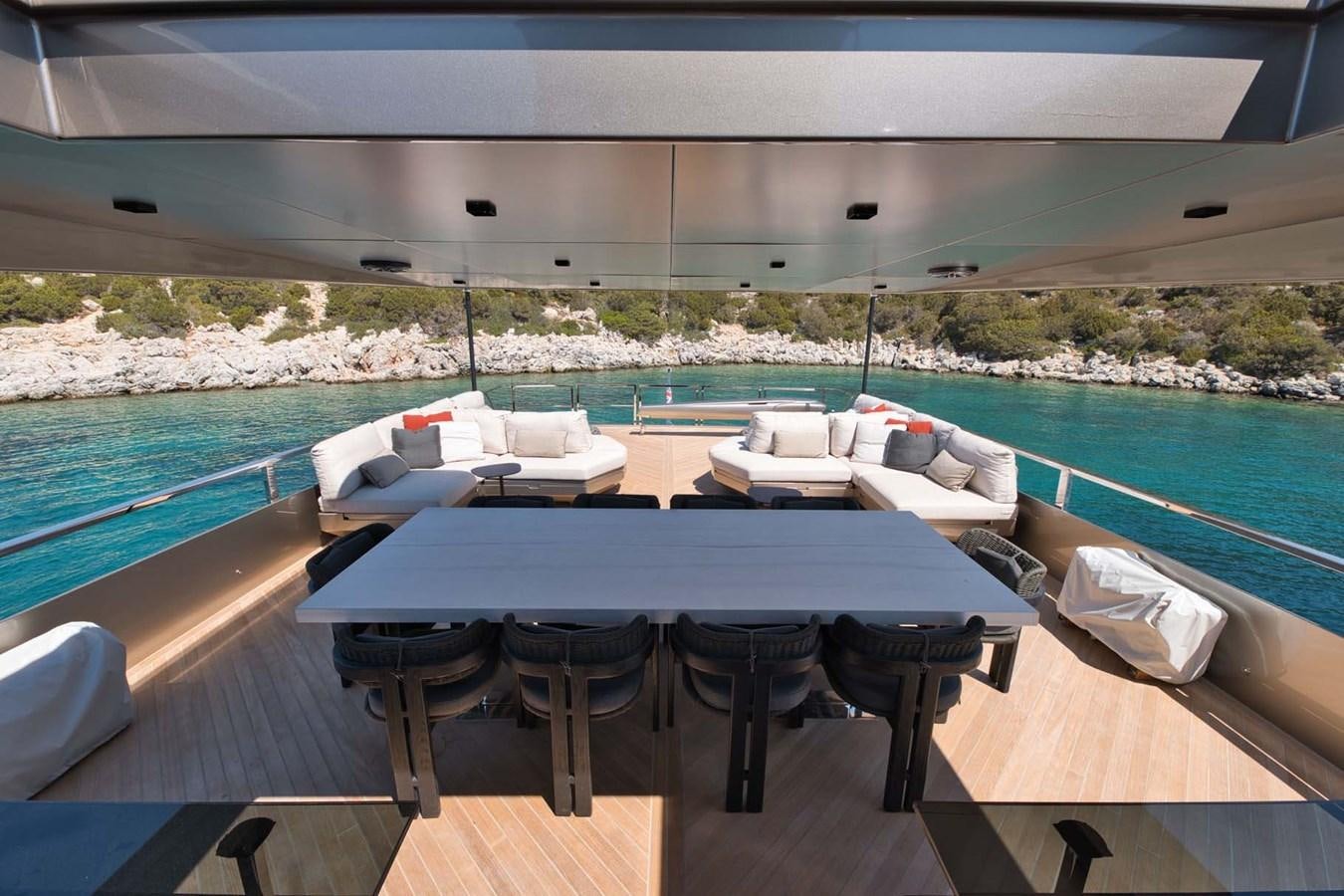 a pool with lounge chairs aboard ROCK X Yacht for Sale