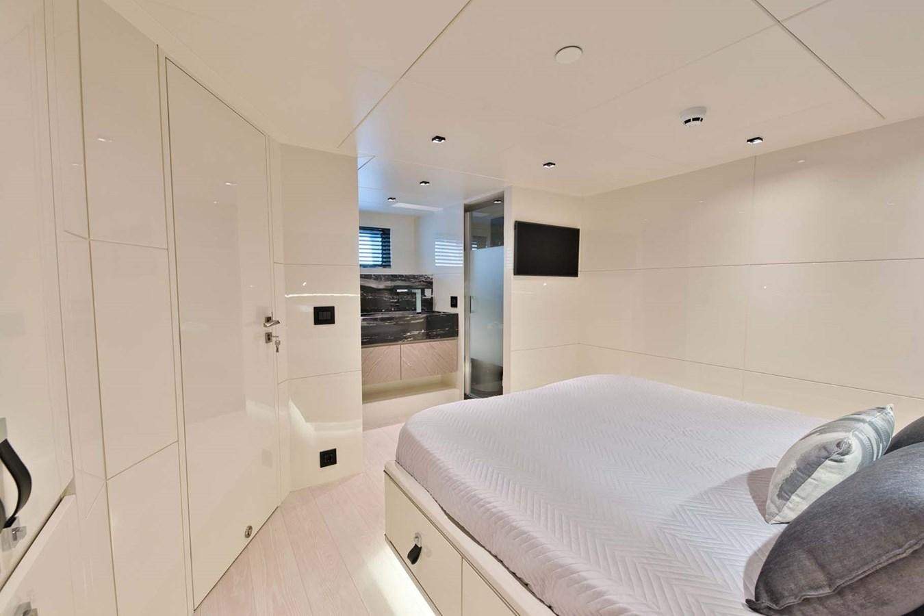 a bedroom with a bed aboard ROCK X Yacht for Sale