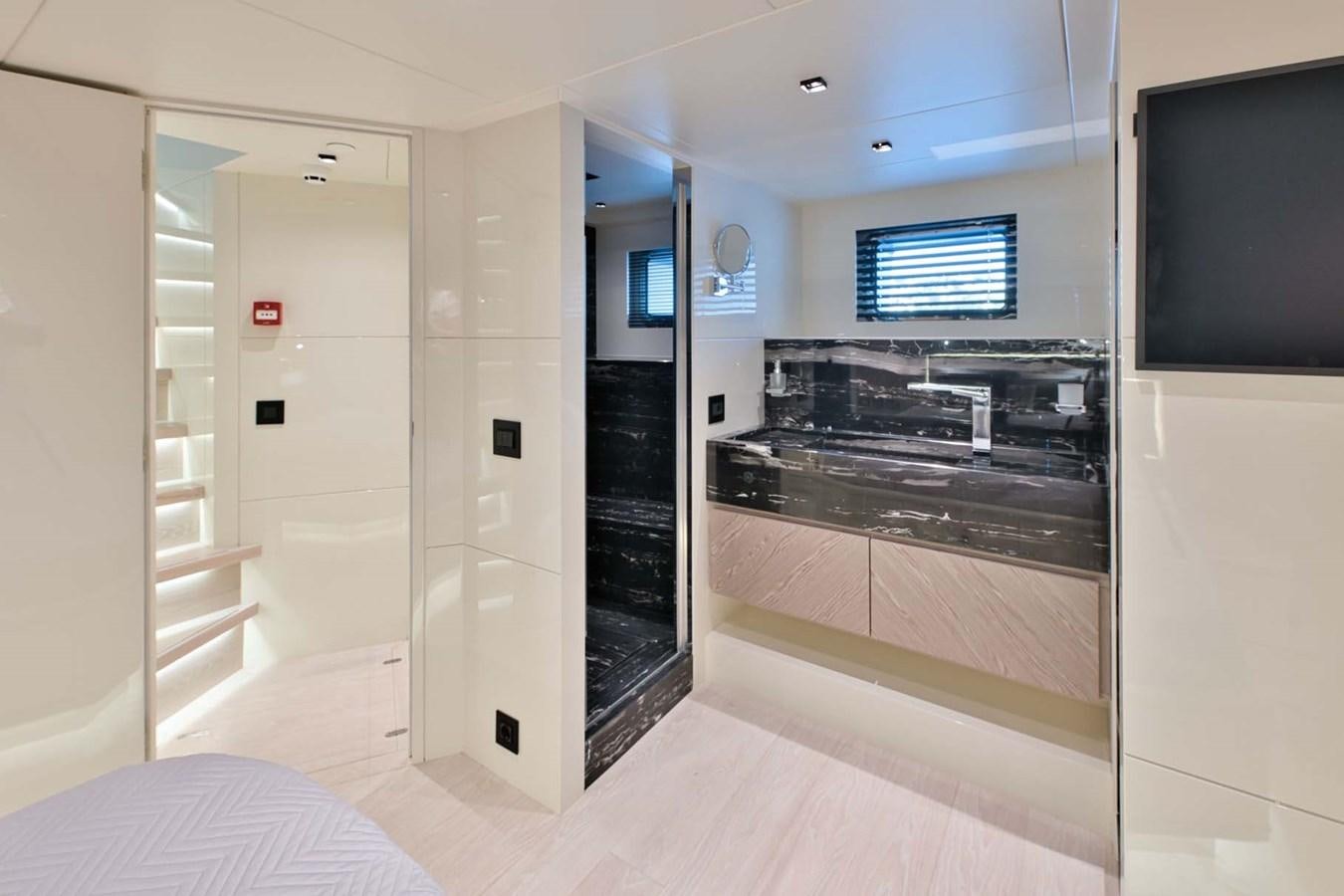 a room with a bed and a tv aboard ROCK X Yacht for Sale