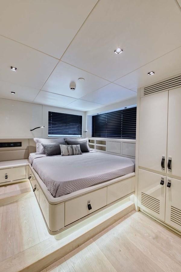 a bedroom with a bed aboard ROCK X Yacht for Sale