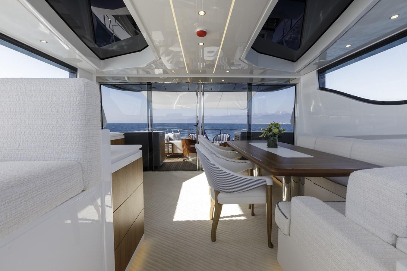 a room with a table and chairs aboard MYSTERE Yacht for Sale