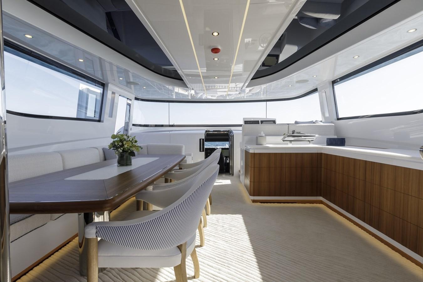 a room with a table and chairs aboard MYSTERE Yacht for Sale