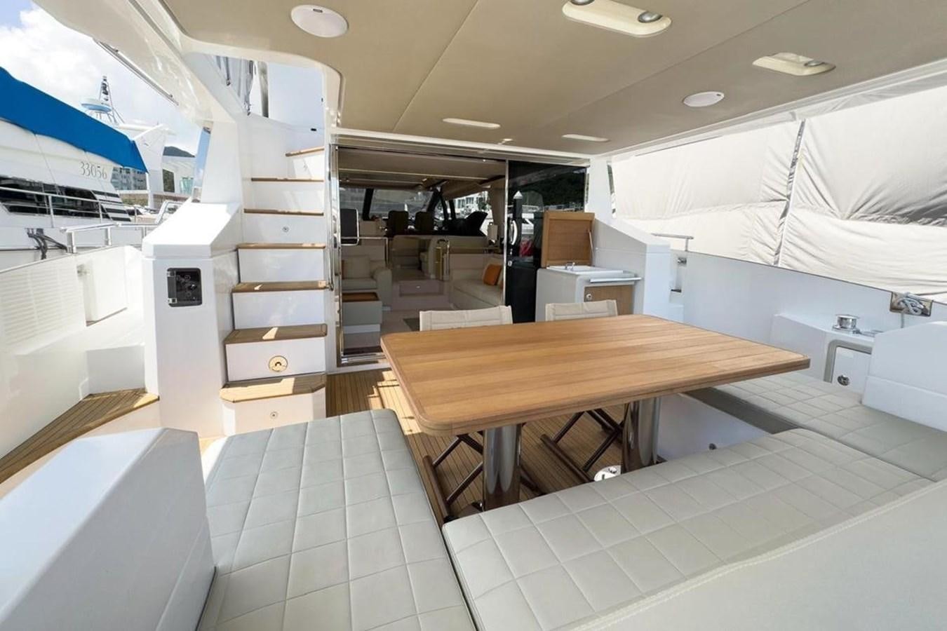 a room with a table and a staircase aboard AZIMUT 66 FLY Yacht for Sale