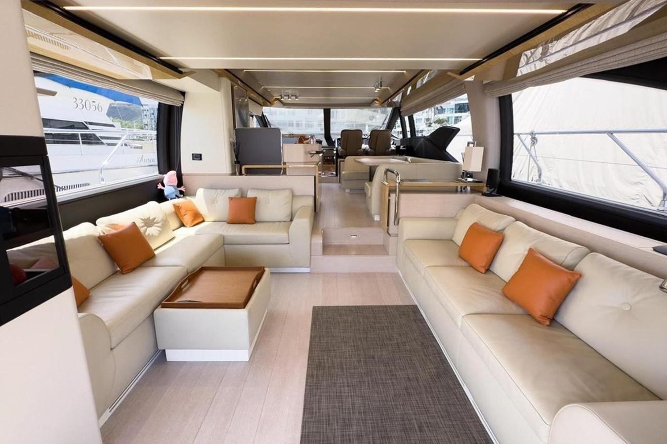 a room with a couch and a tv aboard AZIMUT 66 FLY Yacht for Sale