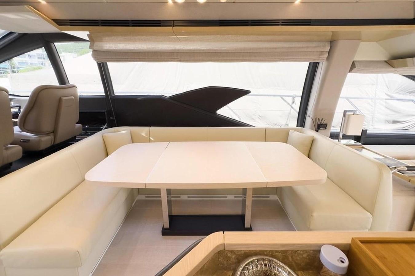 a room with a couch and a table aboard AZIMUT 66 FLY Yacht for Sale