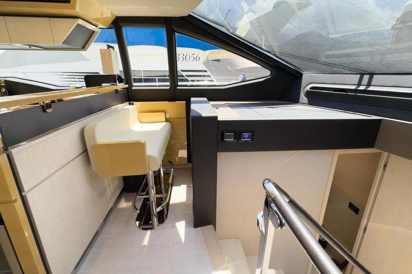 a room with computers and chairs aboard AZIMUT 66 FLY Yacht for Sale