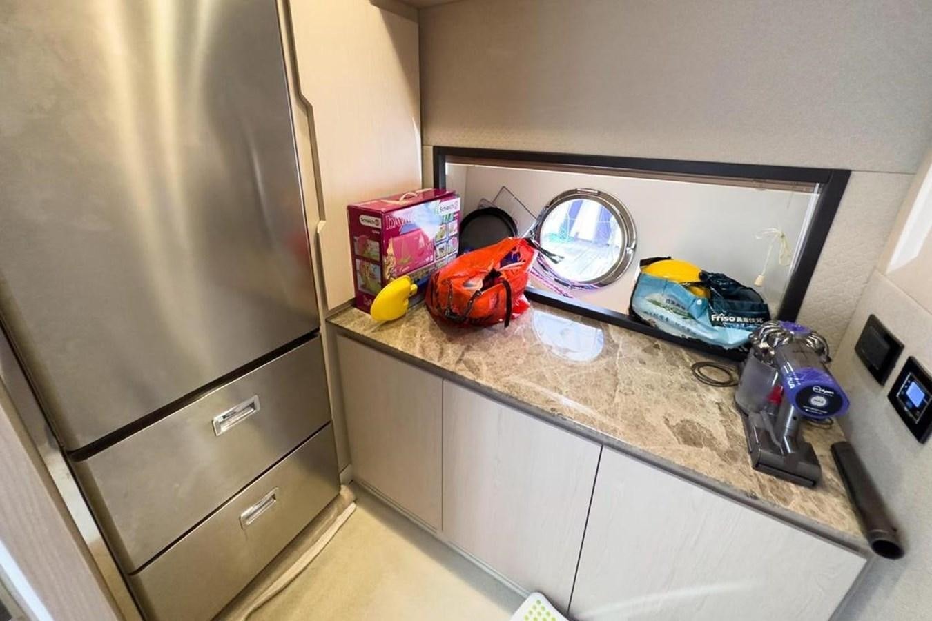 a kitchen counter with a sink and a dishwasher aboard AZIMUT 66 FLY Yacht for Sale