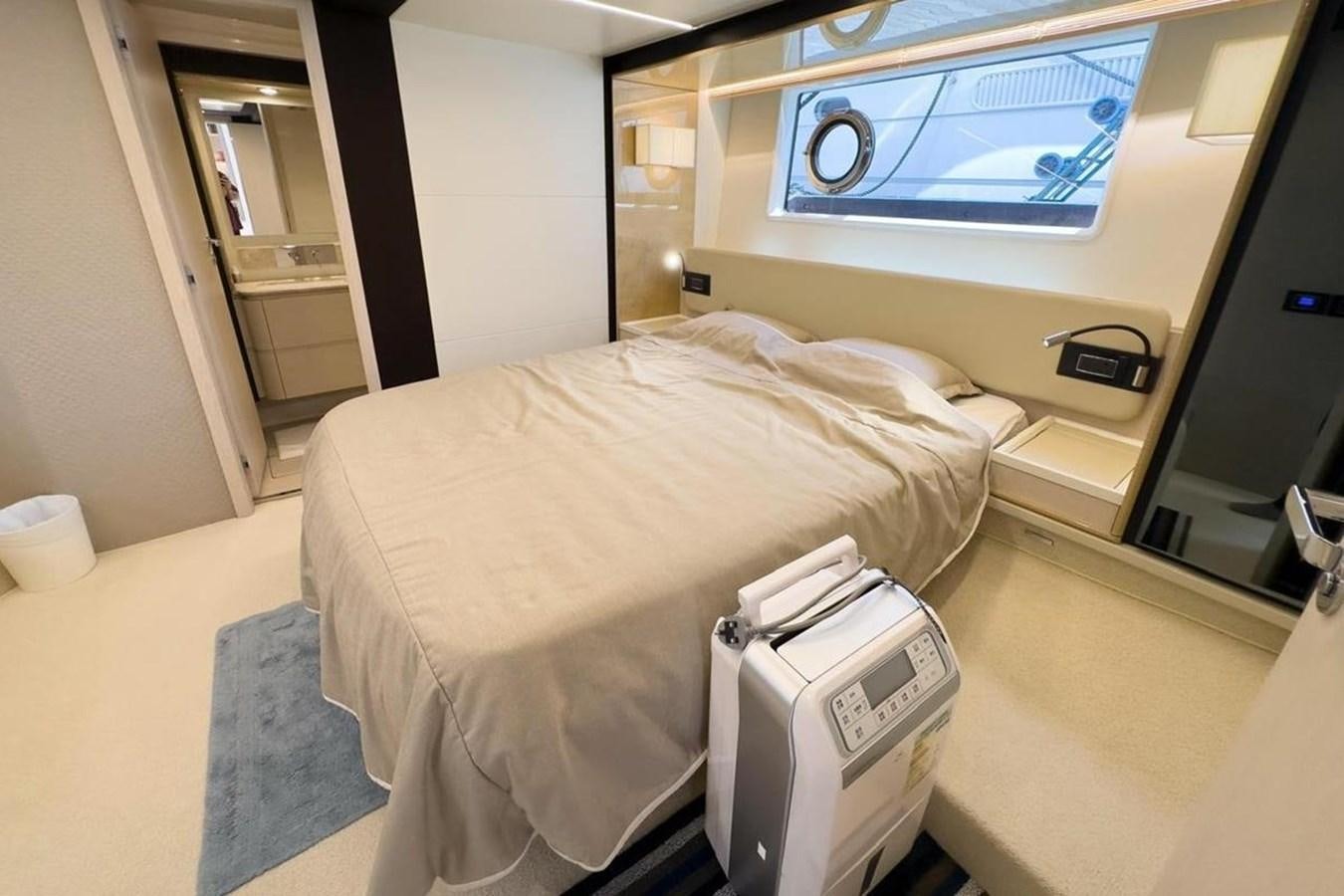 a bed in a room aboard AZIMUT 66 FLY Yacht for Sale