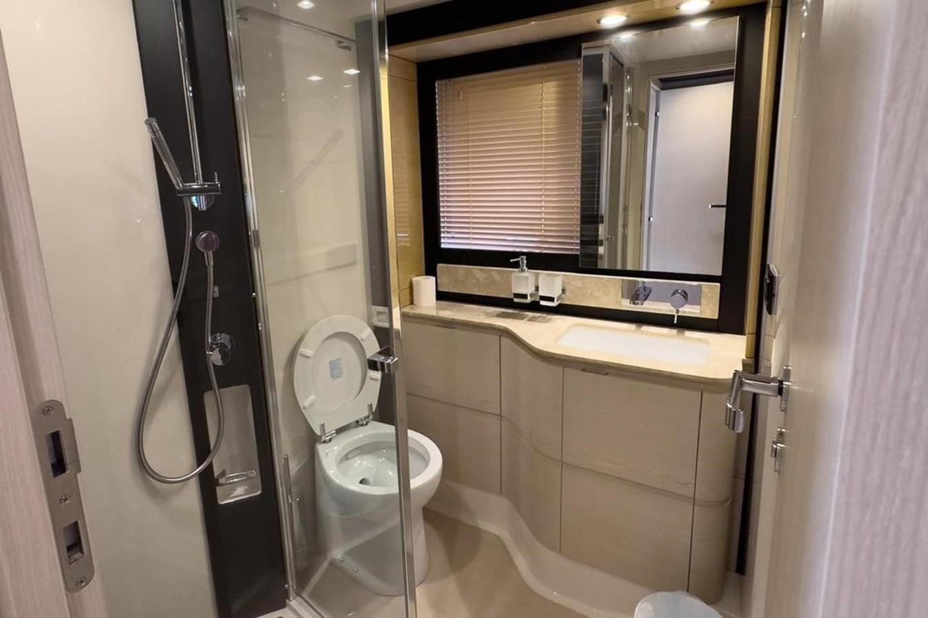 a bathroom with a toilet and a mirror aboard AZIMUT 66 FLY Yacht for Sale