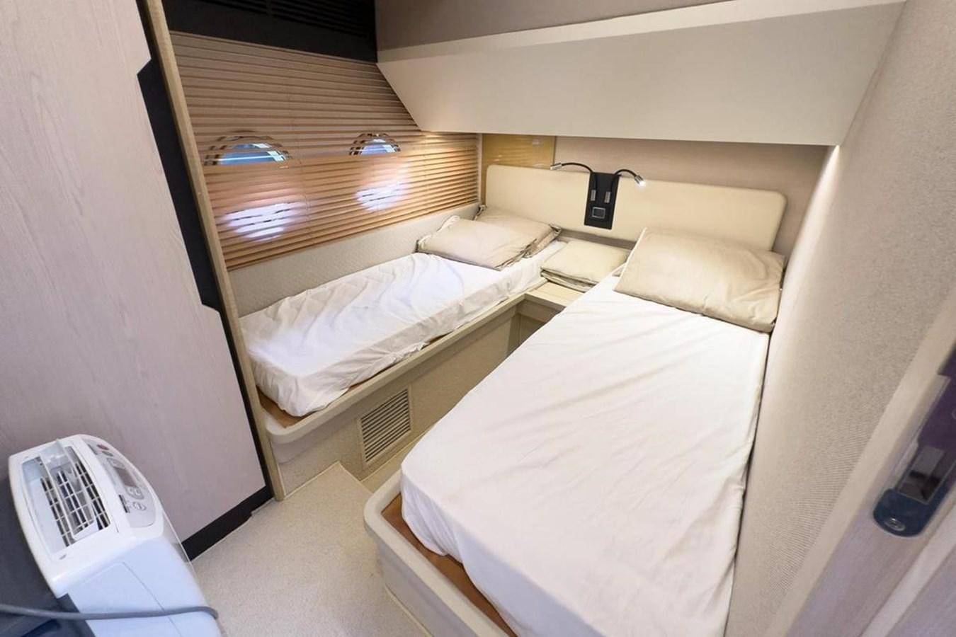 a couple of beds in a room aboard AZIMUT 66 FLY Yacht for Sale
