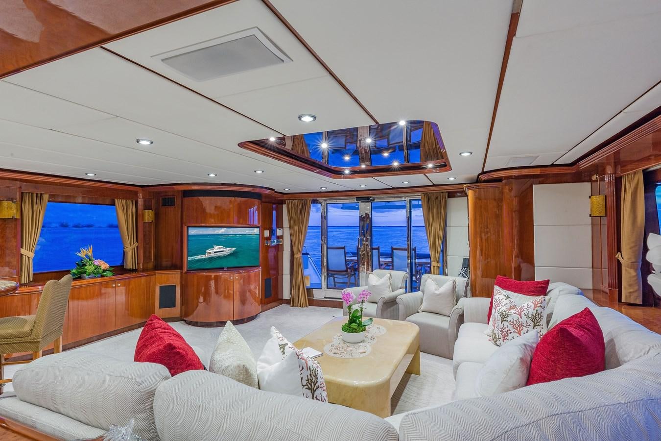 a living room with a large screen aboard QUINTESSA Yacht for Sale