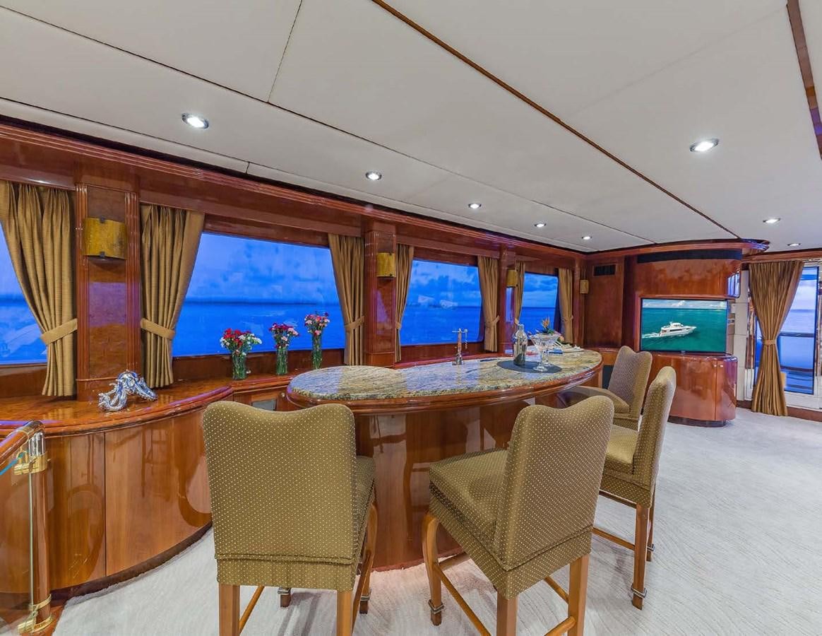 a large dining table in a room aboard QUINTESSA Yacht for Sale