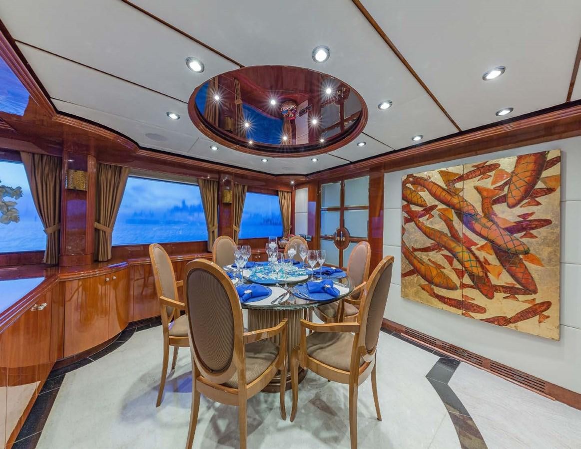 a dining table in a room aboard QUINTESSA Yacht for Sale