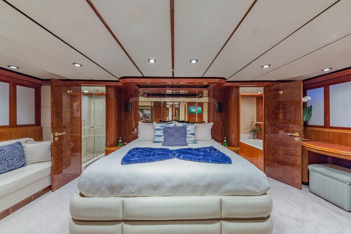 a room with a bed and a mirror aboard QUINTESSA Yacht for Sale