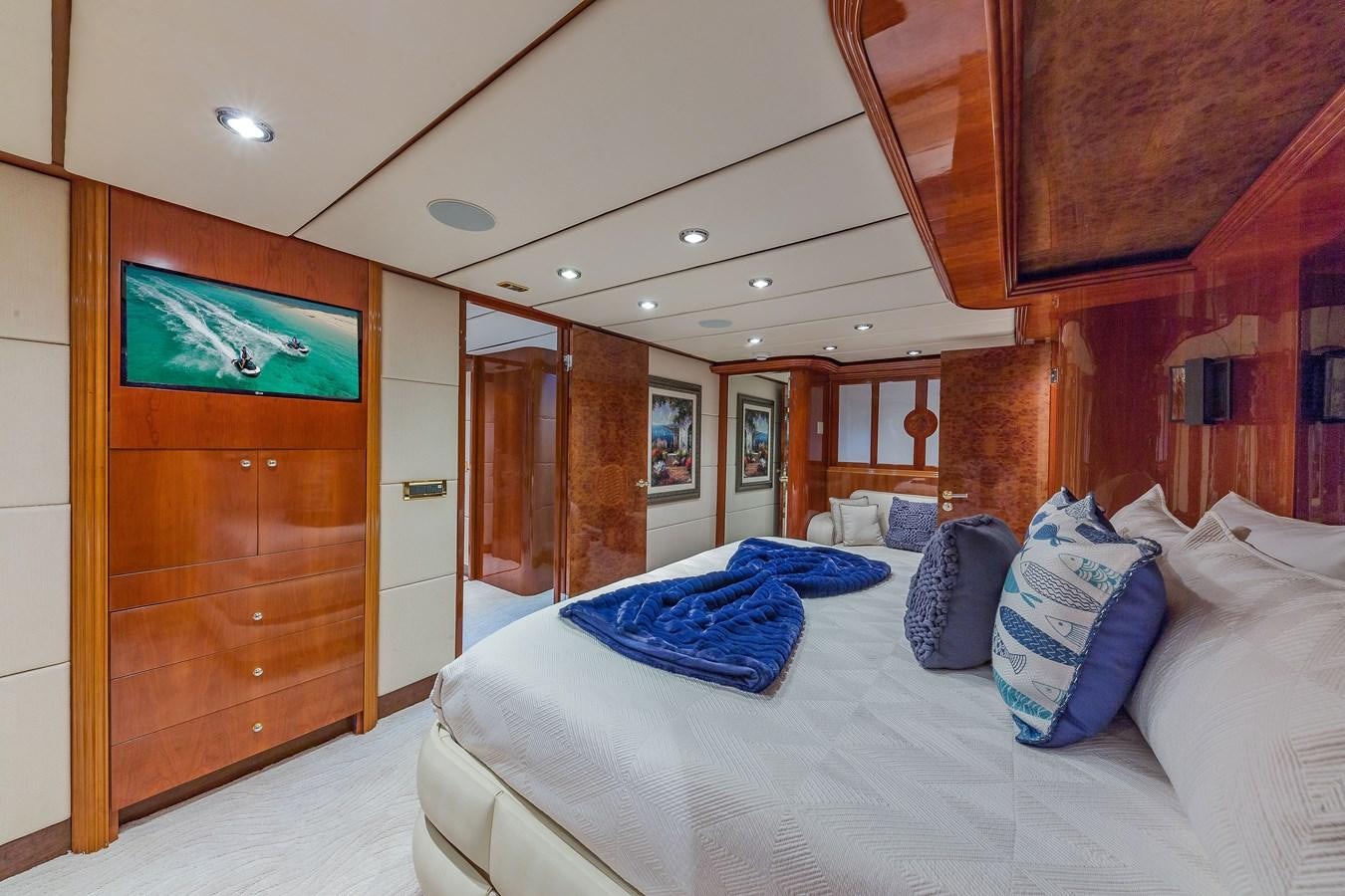 a bedroom with a bed and a television aboard QUINTESSA Yacht for Sale