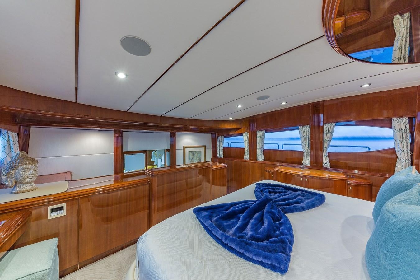 a room with a bed and a wood shelf aboard QUINTESSA Yacht for Sale
