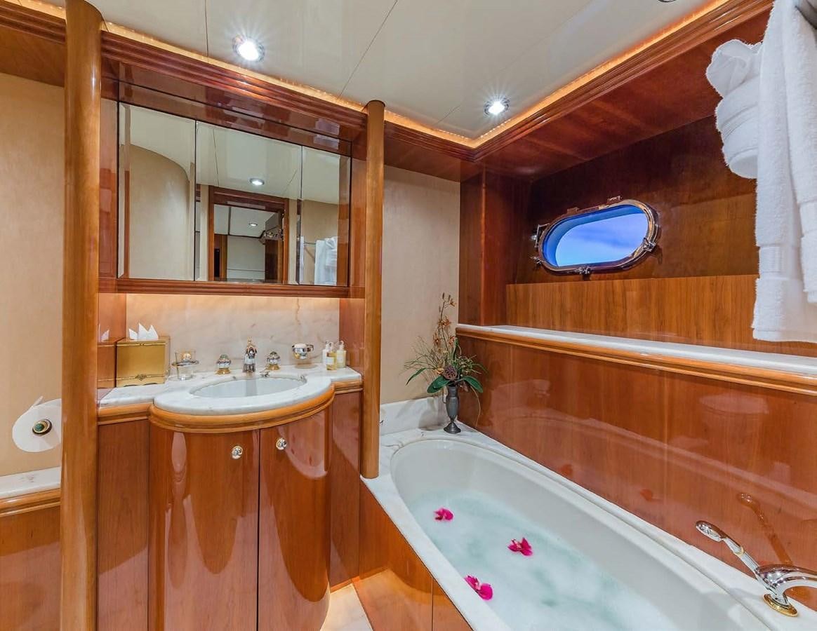 a bathroom with a tub sink and a mirror aboard QUINTESSA Yacht for Sale