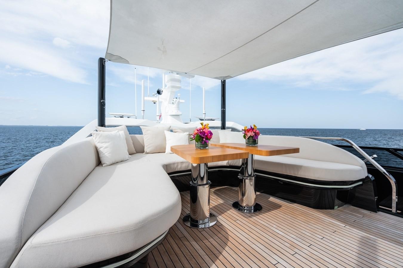 a room with a table and a bed aboard JACQPOT Yacht for Sale