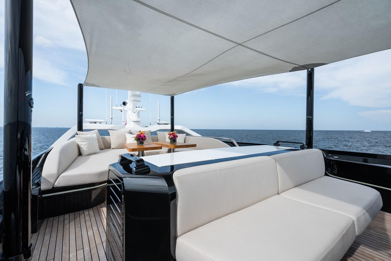 a room with a bed and a table and a window aboard JACQPOT Yacht for Sale