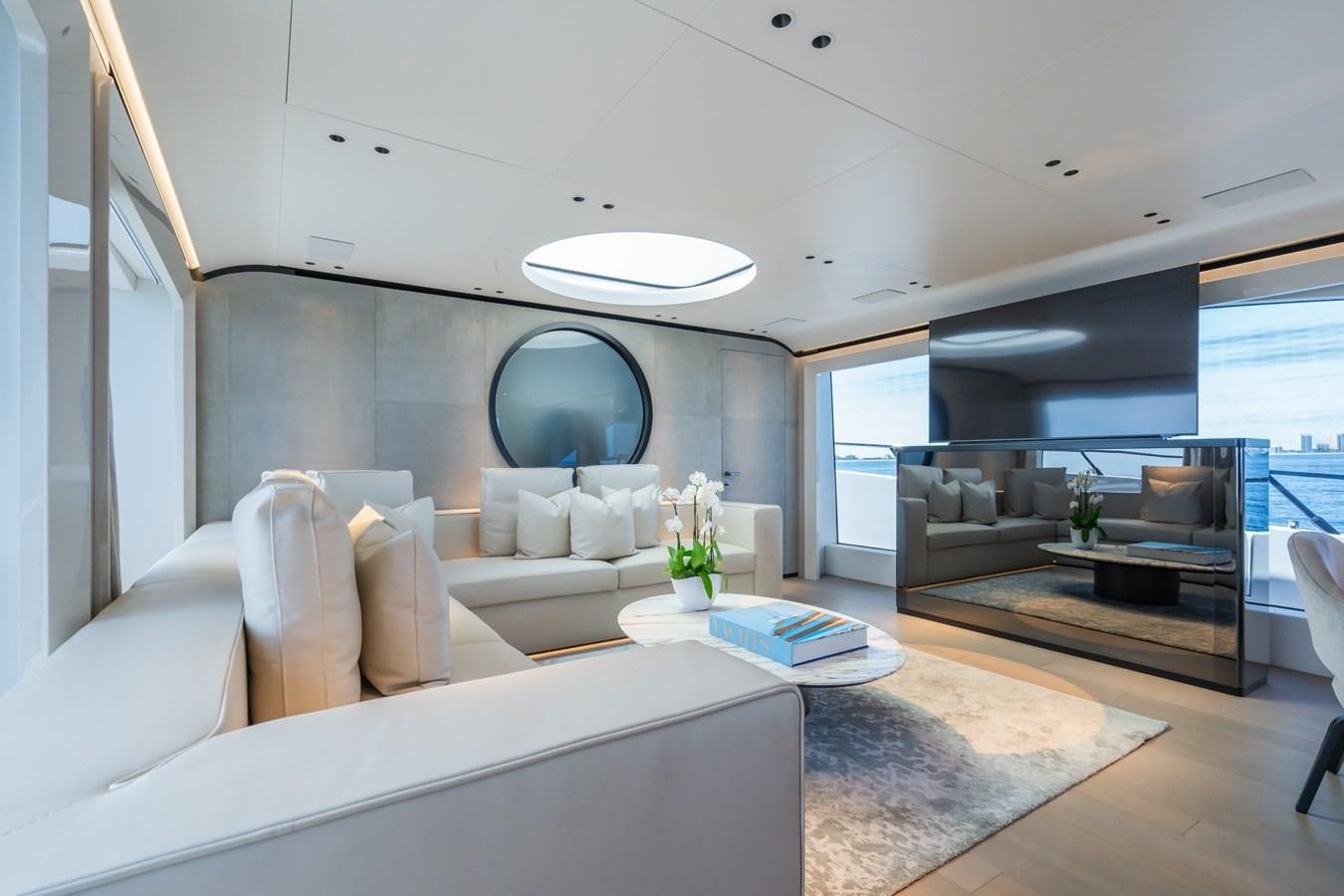 a modern living room with a large window aboard JACQPOT Yacht for Sale
