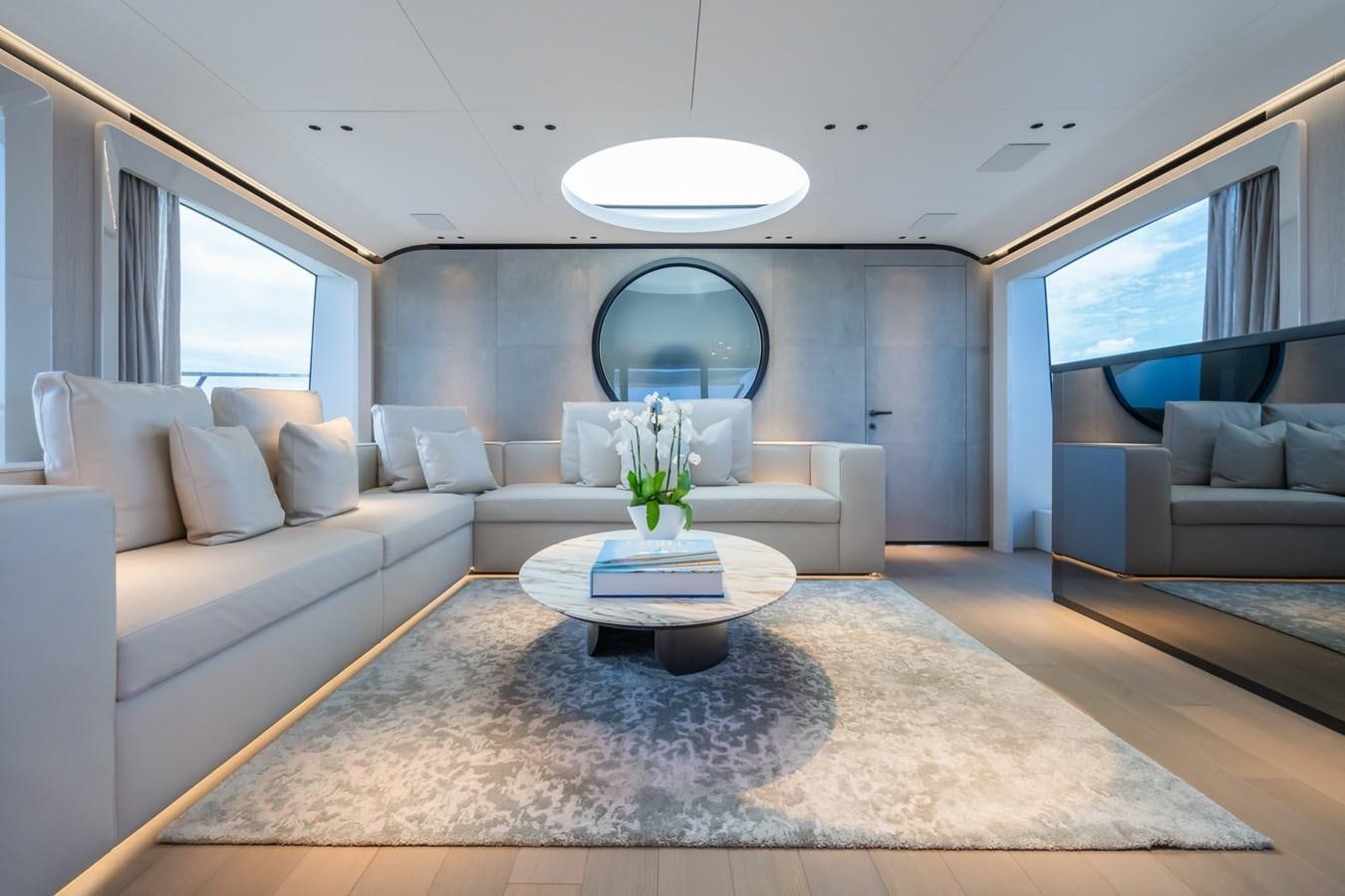 a living room with a large mirror aboard JACQPOT Yacht for Sale