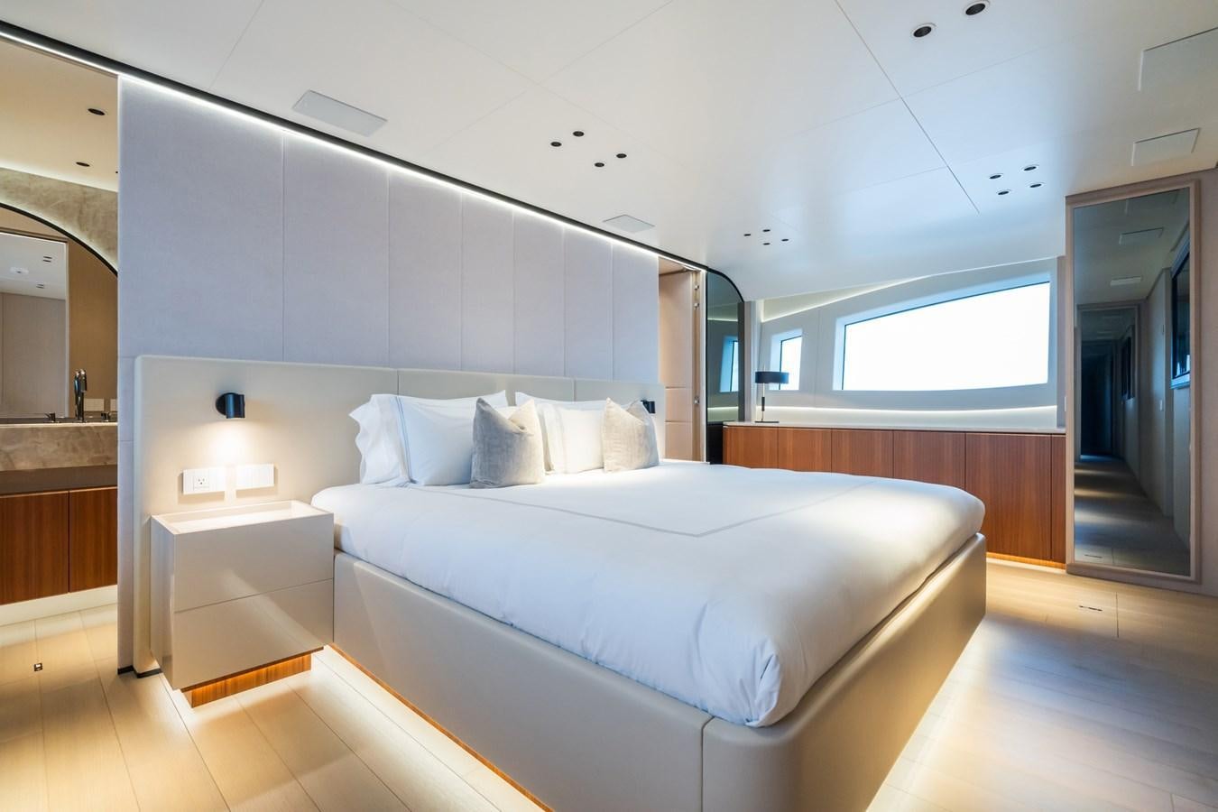 a large white bed in a room aboard JACQPOT Yacht for Sale