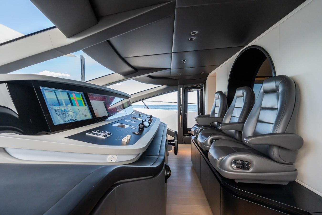 inside of a vehicle with a screen and a computer on the side aboard JACQPOT Yacht for Sale